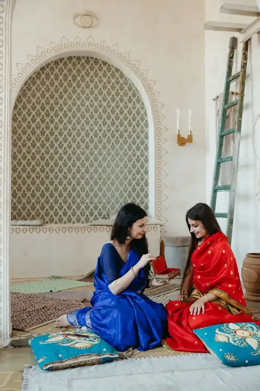 Two women working with lengths of cloth