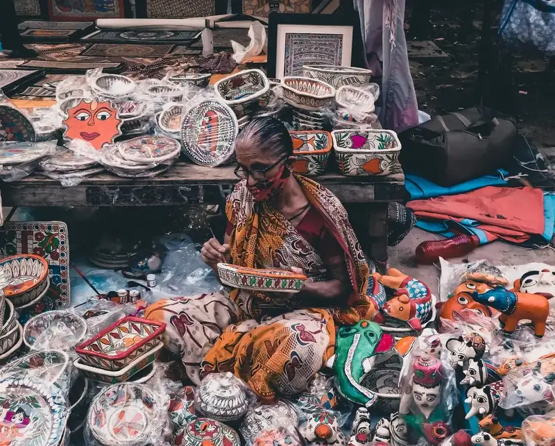 An artisan at work among finished pieces