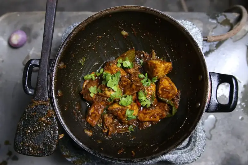 Mutton slow-cooked down to a dark, dry masala
