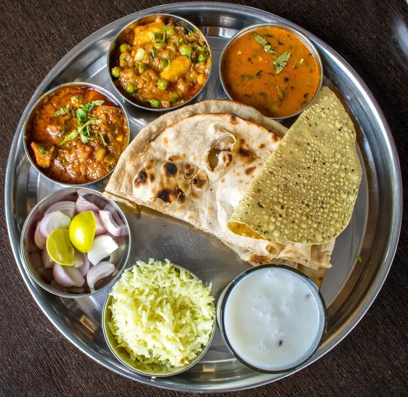 The full thali — nine bowls on one plate